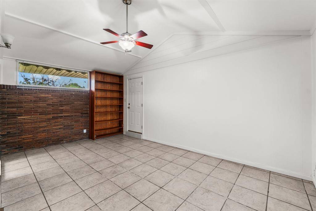 Flex Space - Notice the cathedral ceiling, brick wall, and ceiling fan. The side door leads to the garage.