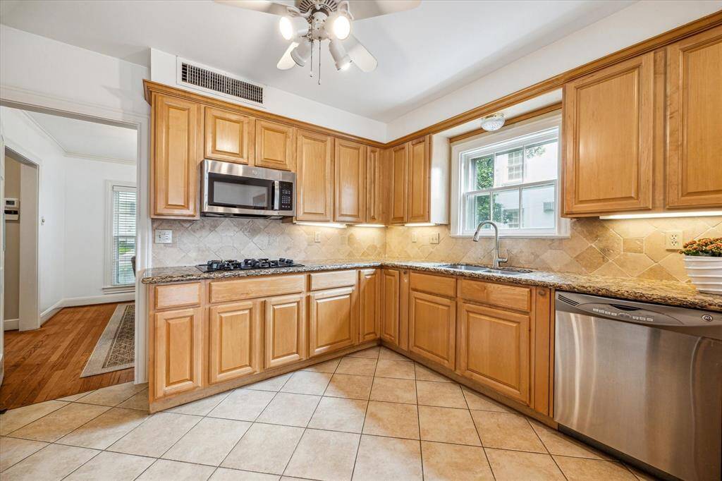Kitchen with gas cooktop top and lots of cabinets for excellent storage.