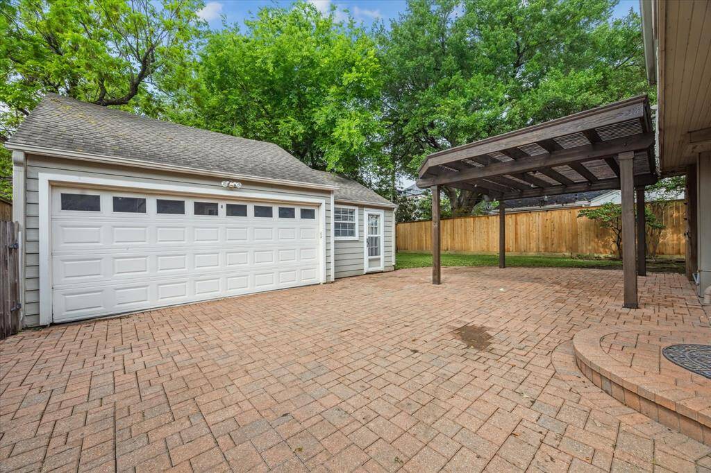 View of garage and flex space with en suite full bath.