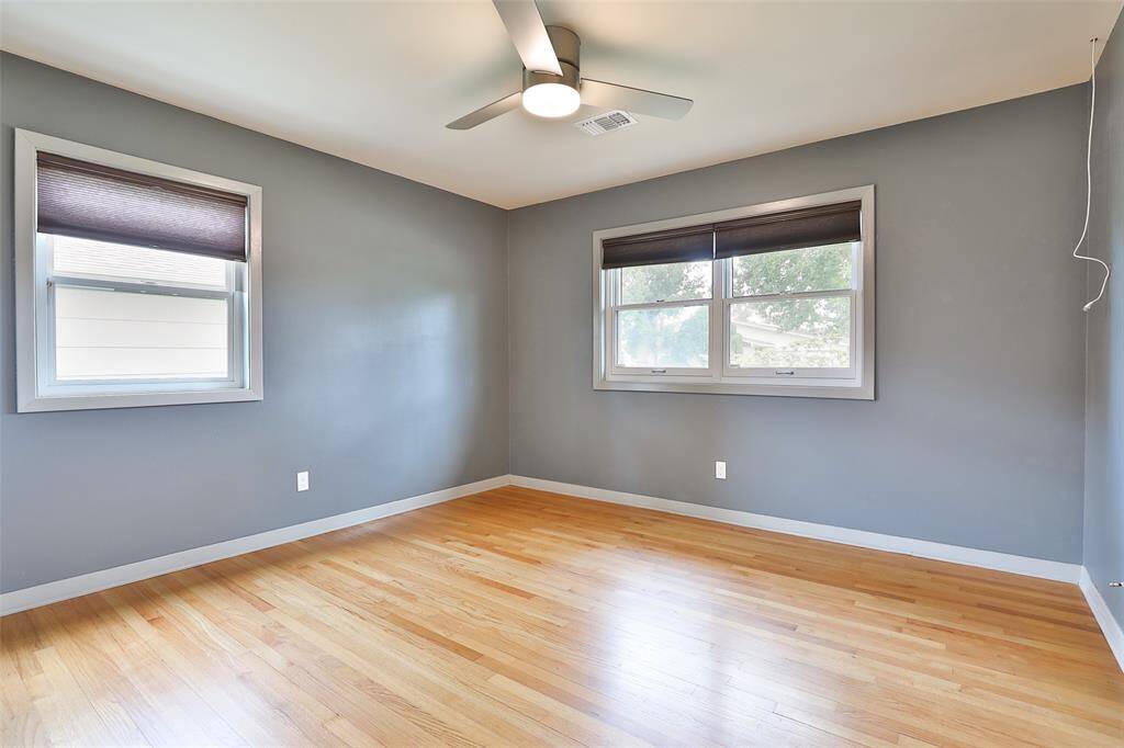 Front bedroom.  Beautiful designer  colors, Roman shades, double paned windows and gorgeous hardwood floors.