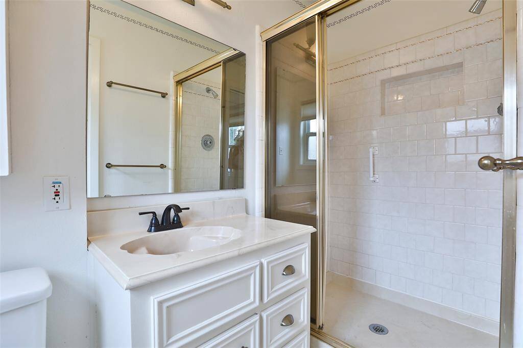 This bath was also remodeled with subway tile in the standing shower and cabinet sink.
