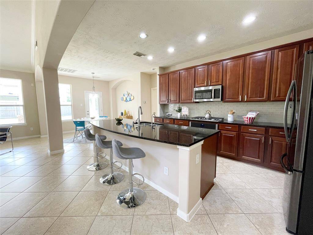 This kitchen features a huge kitchen island to entertain family and friends.
