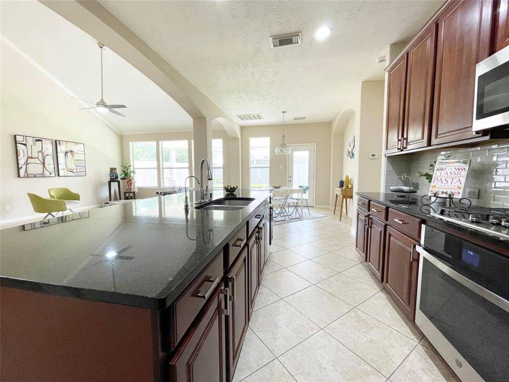 The kitchen is loaded with stainless steel appliances.
