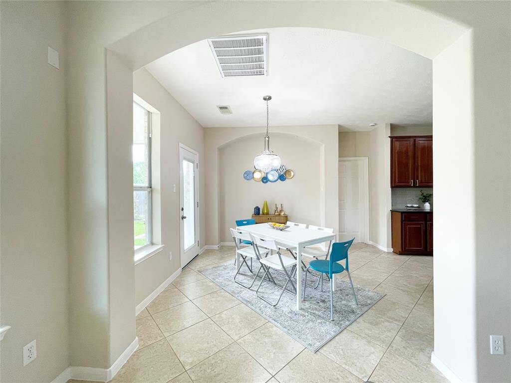 View of the bright breakfast area in this beautiful home.