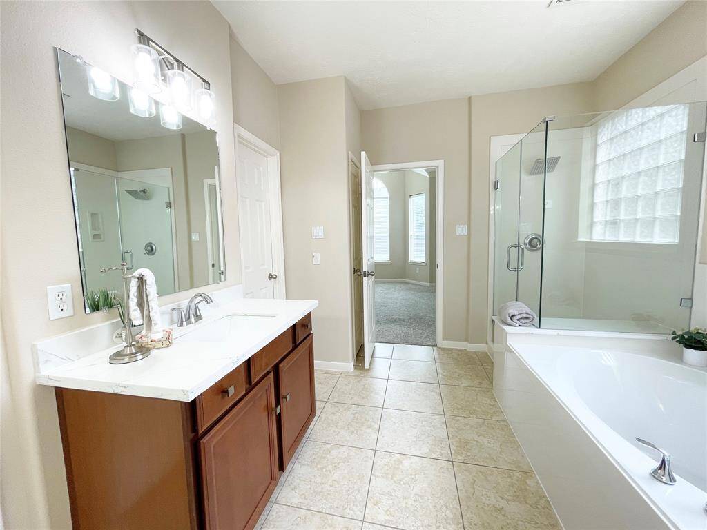 The primary bathroom features quartz countertops.