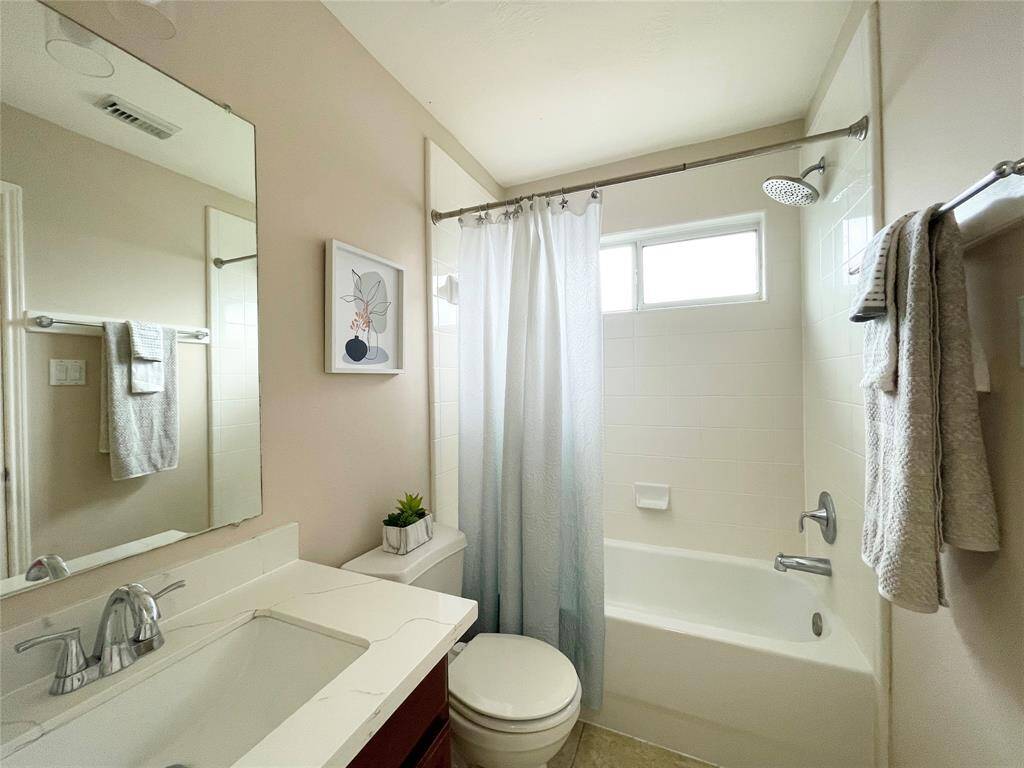 A secondary bedroom upstairs enjoys a private bathroom.
