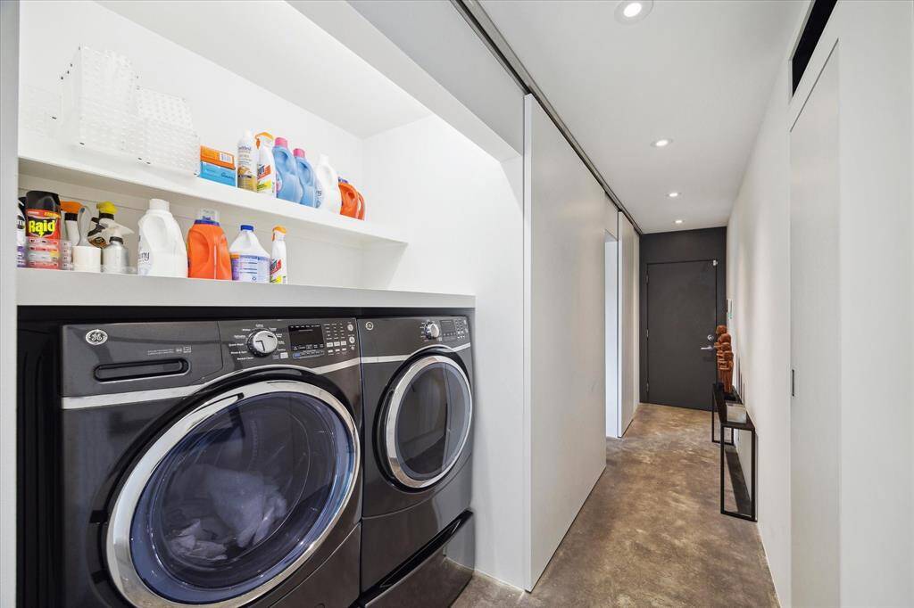 Washer and dryer, located by the home office and downstairs bedroom, can be concealed with a sliding door.