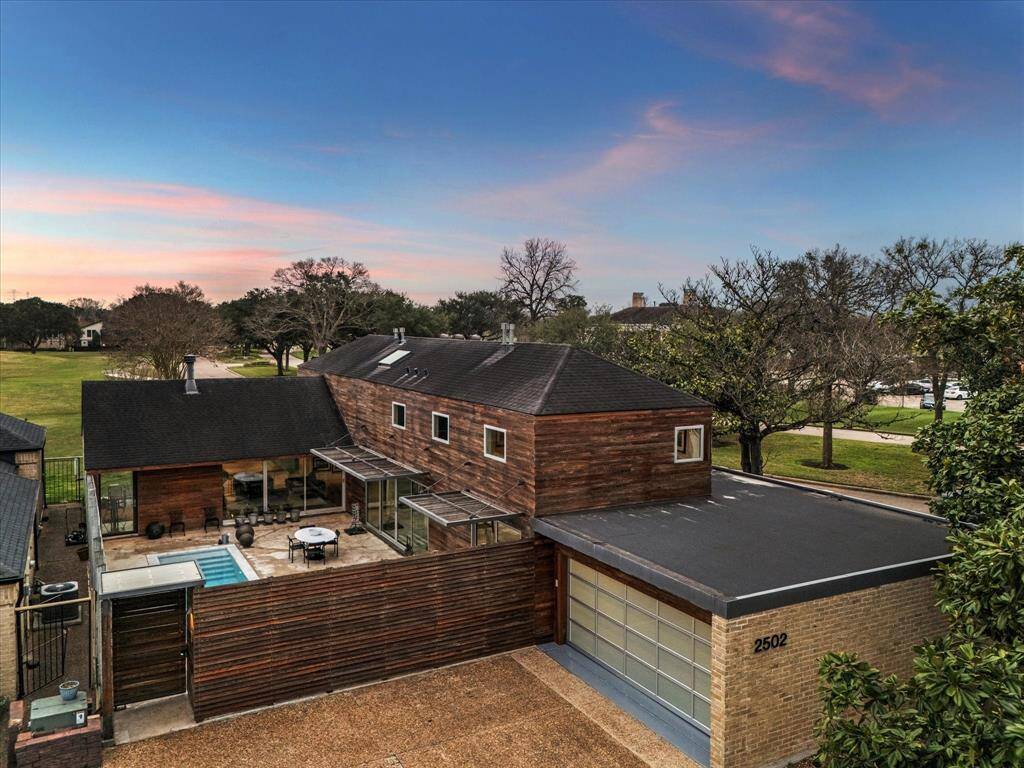 Aerial view showcasing the private courtyard, two car garage and ample extra off-street parking for guests.