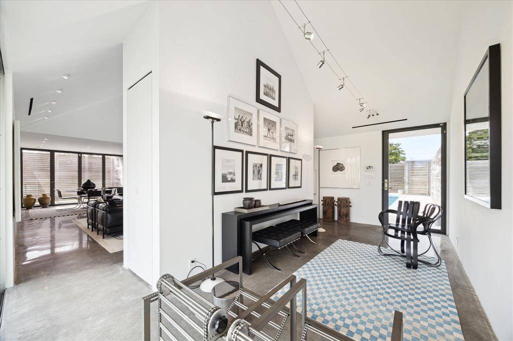 View from the front room to the open concept living and dining areas showcasing the sleek, polished concrete floors presented on the first floor.