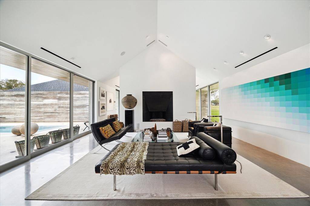 Modern gas-log fireplace in the living area with views to the courtyard. Glass doors to the left open fully offering a perfect atmosphere for entertaining.