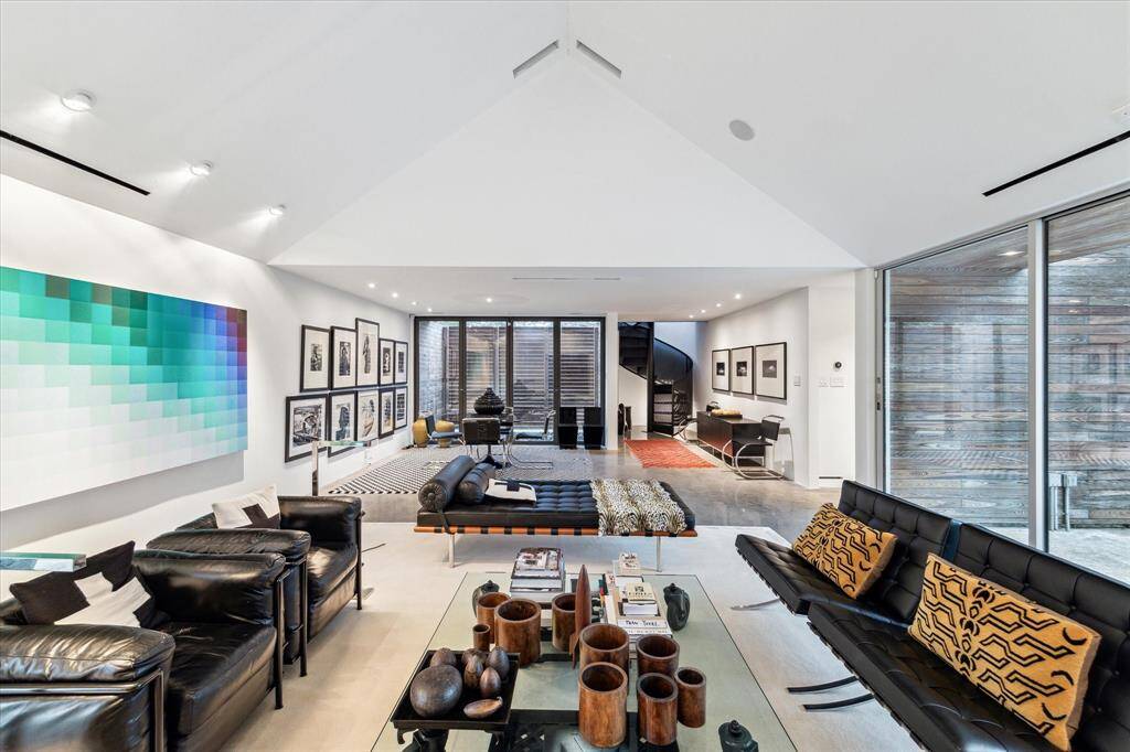 Gallery style LED lighting and vaulted ceilings enhance the ambience and sophistication in the open concept living area.