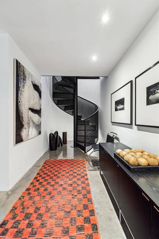 Steel mesh metal stairway leading to the incredible primary retreat and secondary bedroom.