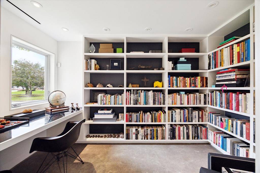 Light and bright home office with built-in desk and bookcases.