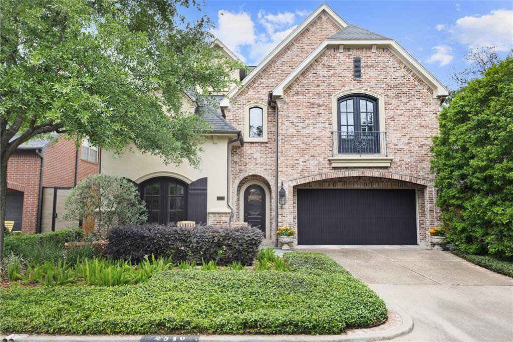 This home features a charming brick exterior with a two-car garage and a beautifully landscaped front yard. The contrasting dark window and door frames add a touch of elegance. Ideal for buyers seeking a blend of classic and modern design.