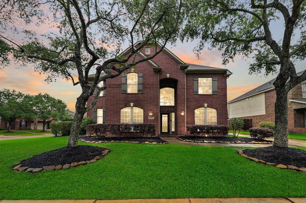 Stately red brick two-story home nestled on a corner lot in the master-planned West Ranch community, zoned to highly acclaimed Friendswood ISD. Lush landscaping, mature shade trees, and a welcoming arched entry create timeless curb appeal.