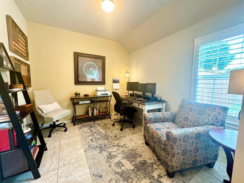 To the right of entry is an office or formal living room.