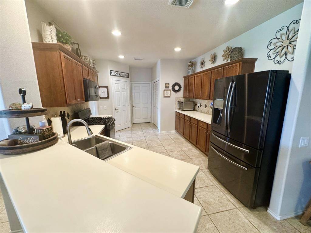 3 doors in kitchen are: pantry, garage entrance and laundry area.