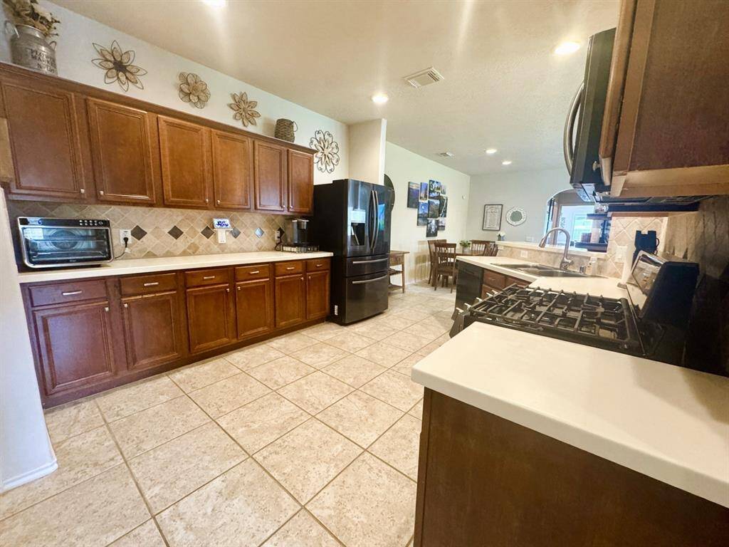 This kitchen has a lot of counter space and cabinets.