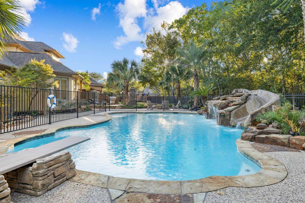 Protected pool has waterfall and slide
