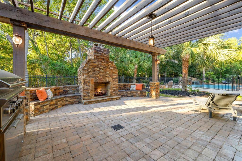 Hige patio with grill, bar and stone fireplace