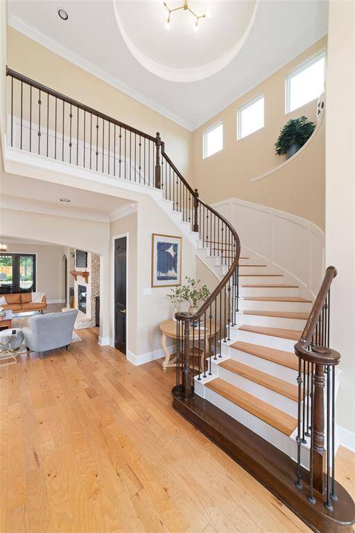 Stunning Grand Entrance w amazing wood flooring, soaring ceilings and gorgeous curved staircase.