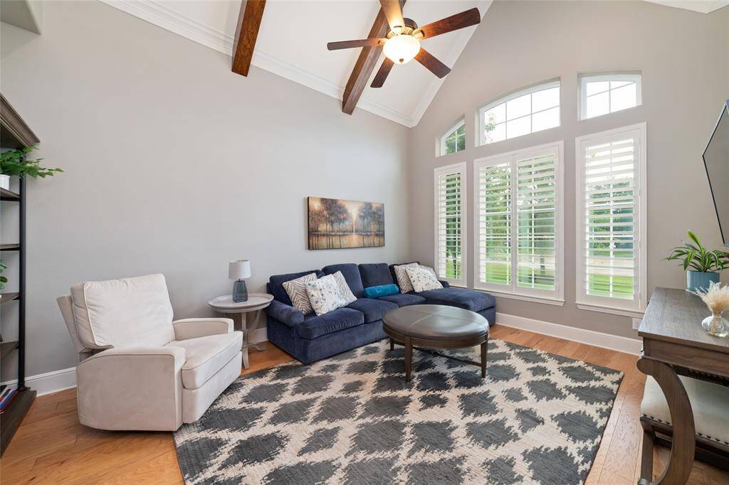 Private study w vaulted wood beam ceilings and beautiful shutters covering the windows.