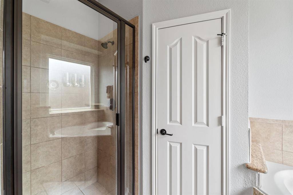 This beautiful Primary Bathroom features a gorgeous tiled walk-in shower.