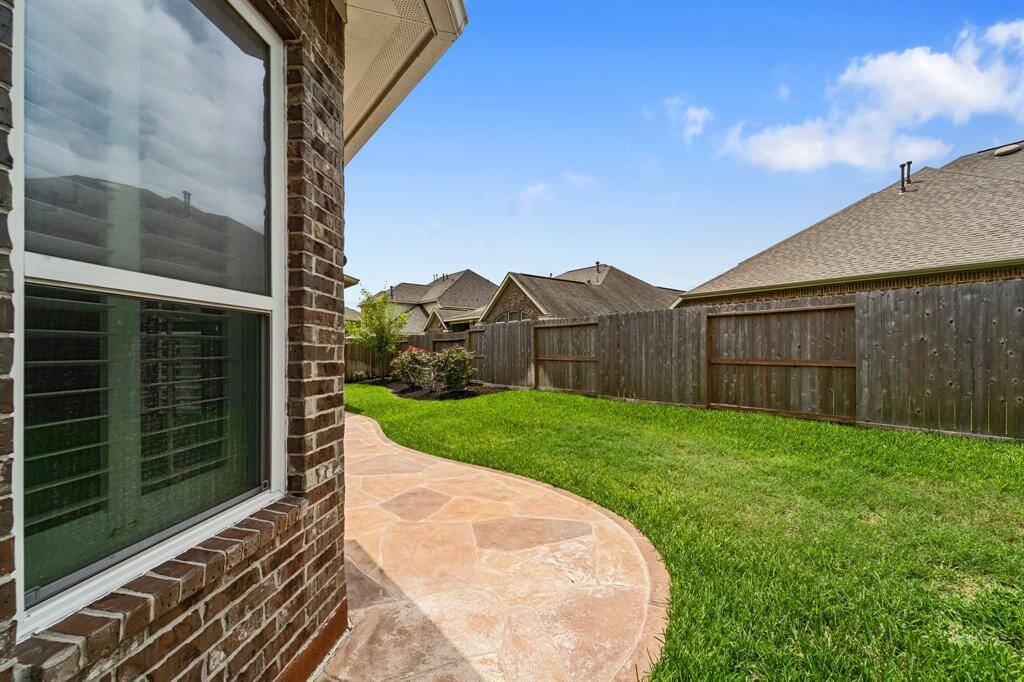 This backyard features new solid board fencing providing more privacy.