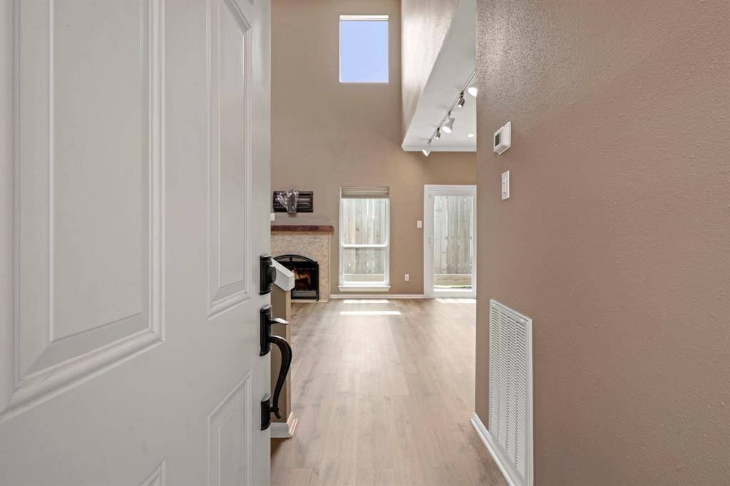Entry - Step inside to see a wall of windows and double height ceiling which make this home feel spacious.