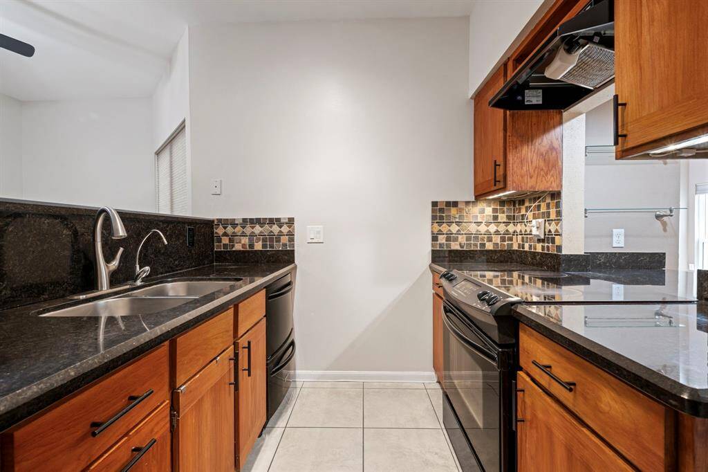 Kitchen - Pass through to the right opens to the bar which could also be used as a buffet. What a great home for entertaining!
