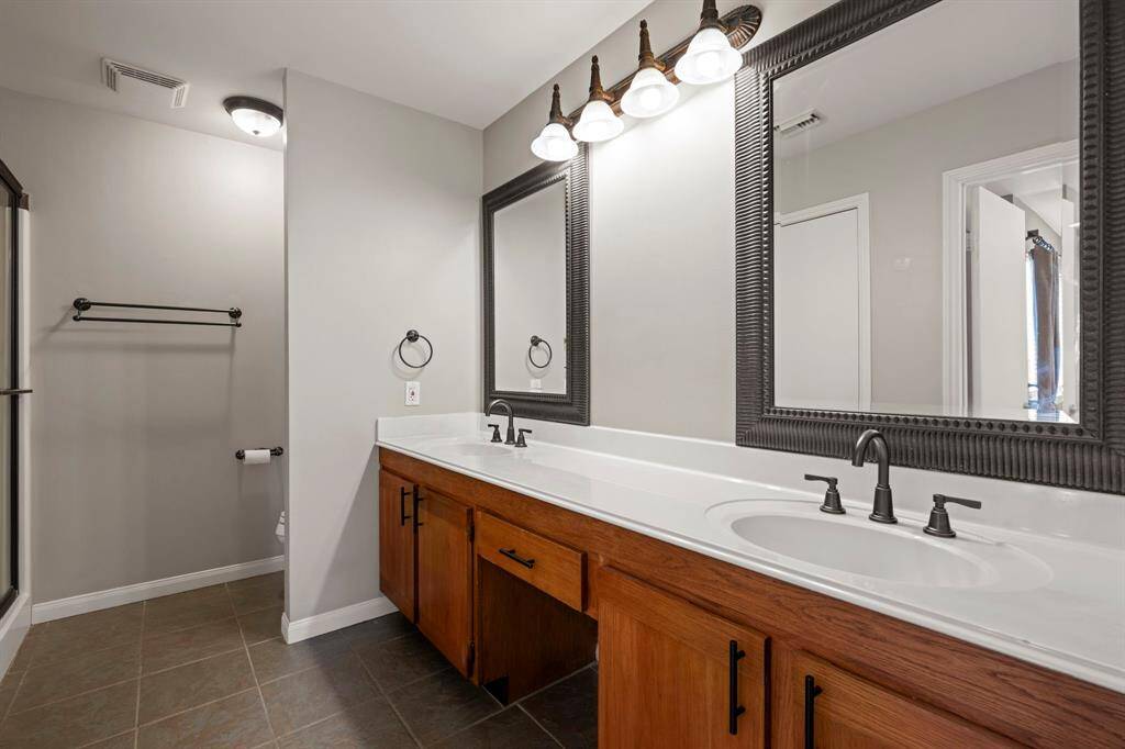 Primary Bathroom (Level 2) - Double sinks with vanity between.