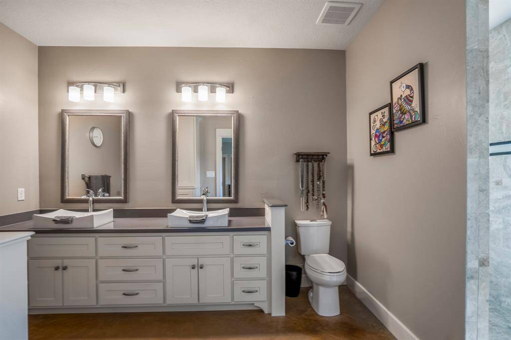 Main home, primary bath vanity area and access to walk in shower