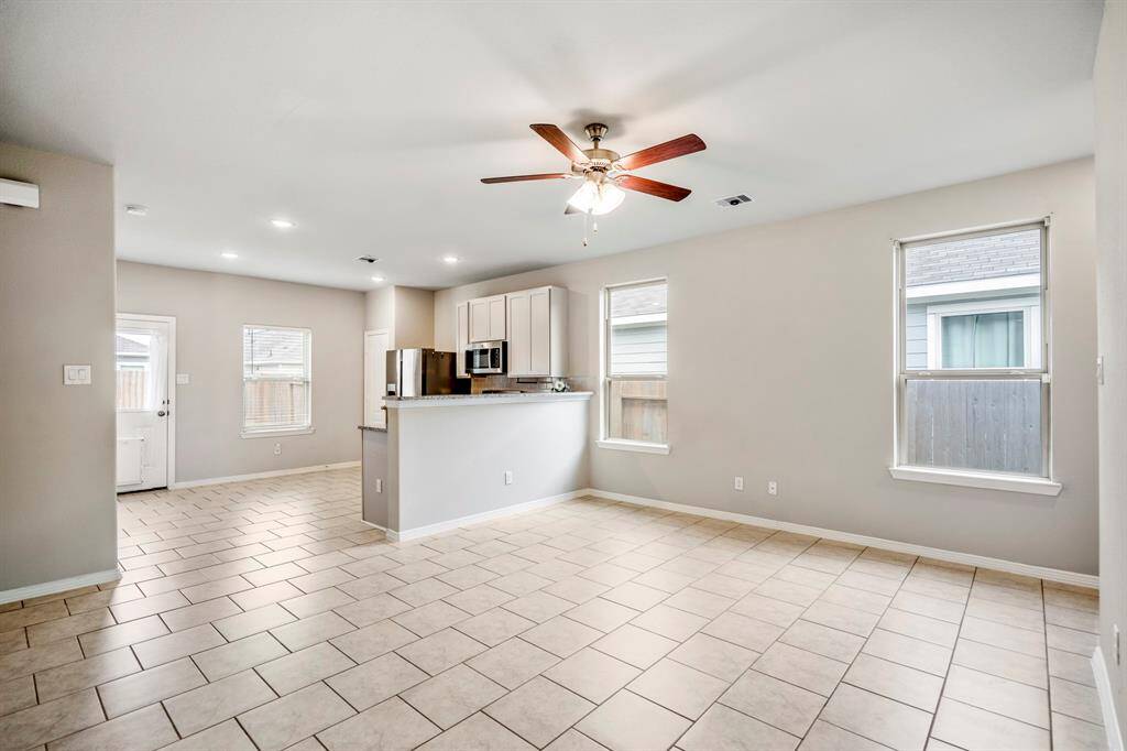 Open concept Living Room and Kitchen, recessed lighting and ceiling fan.