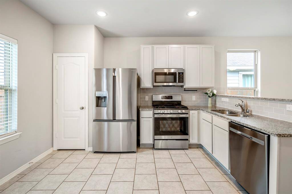 Light and bright Kitchen featuring stainless-steel appliances.  Plenty of room for entertaining.