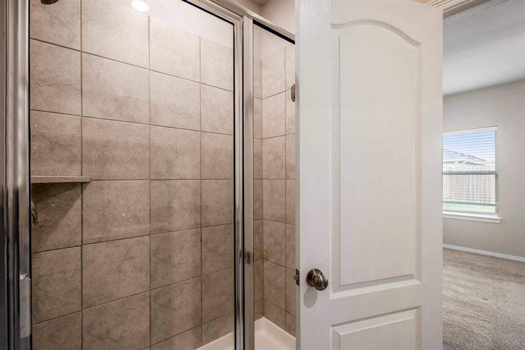 Oversized primary Bath features a tiled, walk-in shower.