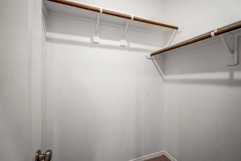 You will have tons of space for all your things in this primary walk-in Closet