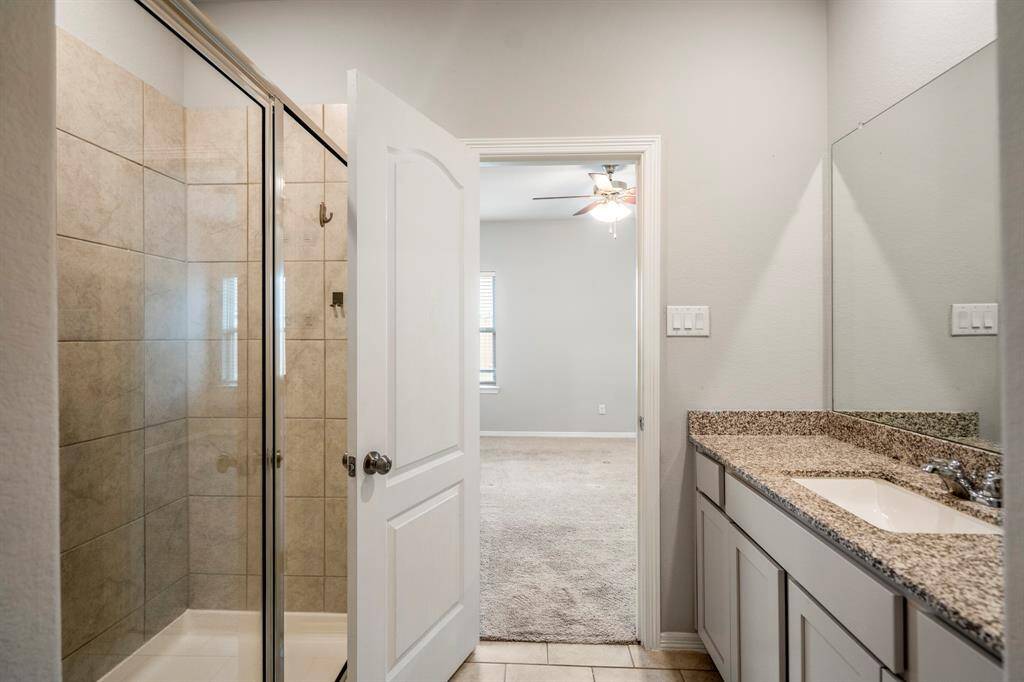 Tons of counter space, storage, and a large mirror make getting ready in this primary bath a treat!