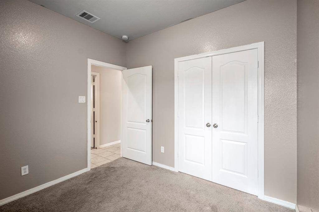 Large closet with double doors provides extra storage.