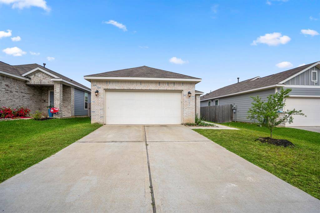 Double-wide driveway leads to a two-car Garage