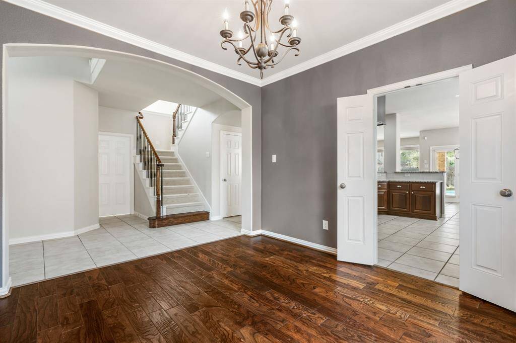 Another view of the dining room, kitchen and stairs leading to the upstairs. Laundry room is through the door on the left and the 3 car garage is next to the laundry room.