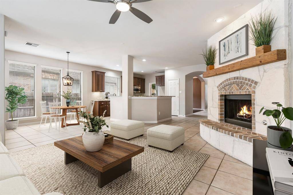 Staged living room and breakfast area that shows the open area to the kitchen.