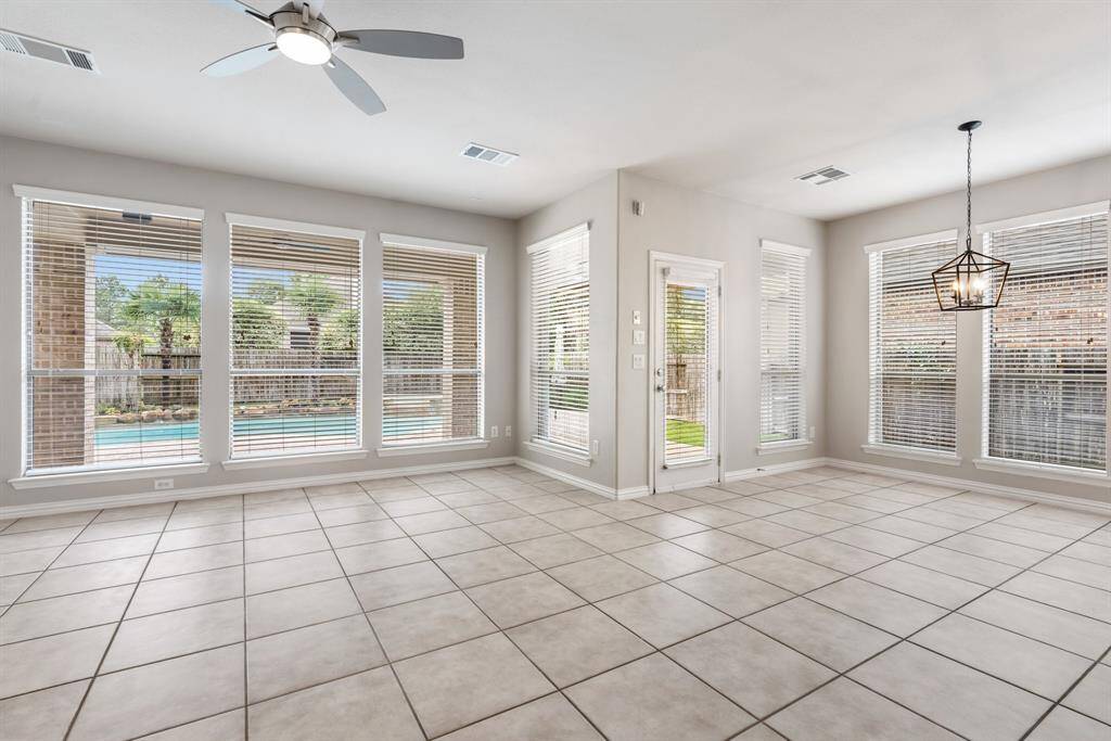 Another view of the living and breakfast area that has a door leading to the covered patio and backyard with swimming pool and hot tub.