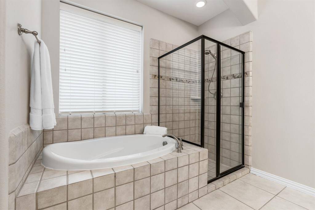 Jacuzzi soaking tub with separate shower.