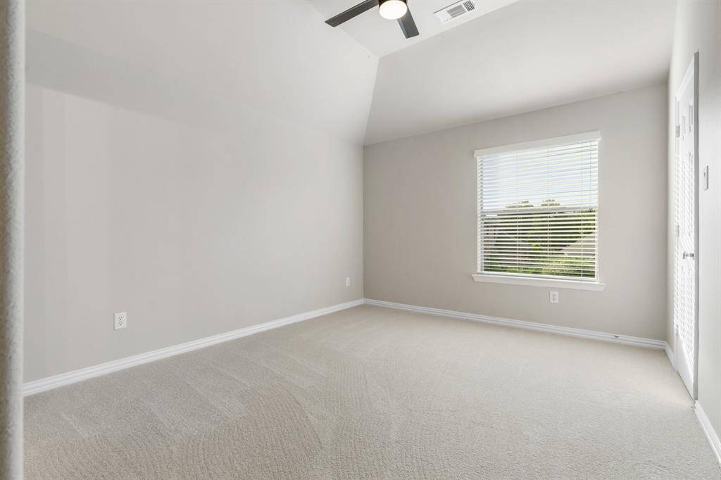 Secondary bedroom upstairs with ceiling fan, walk in closet and jack and jill bathroom.