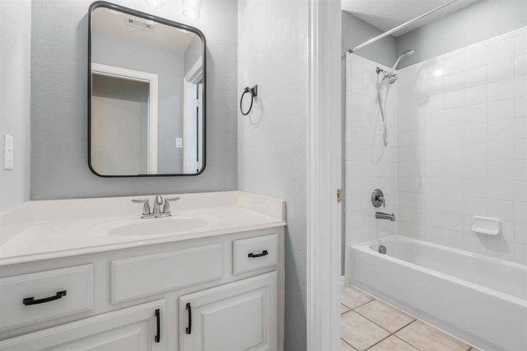 ack and Jill bathroom with updated lighting and mirror.