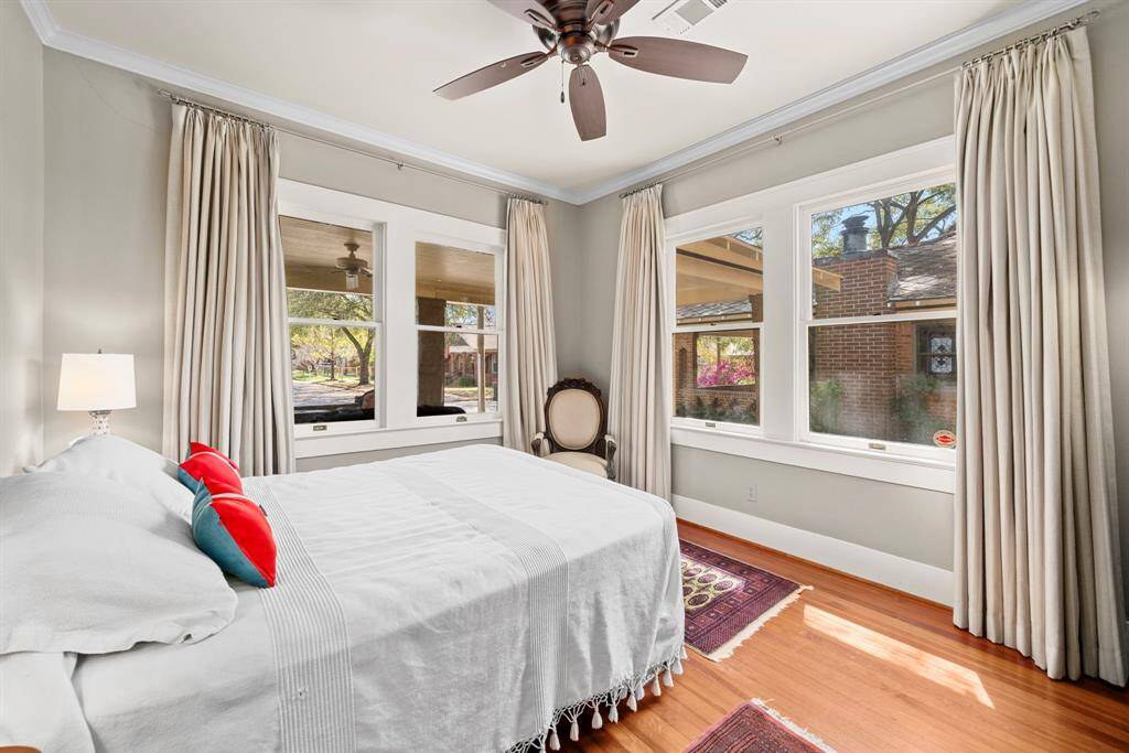 Large windows in the primary bedroom allow this room to feel bright and alive, while custom drapes black out the space at night.
