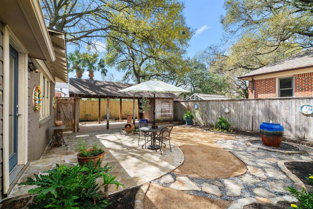 Lovely, low maintenance and peaceful hardscaped backyard with paver patios and a waterfall.