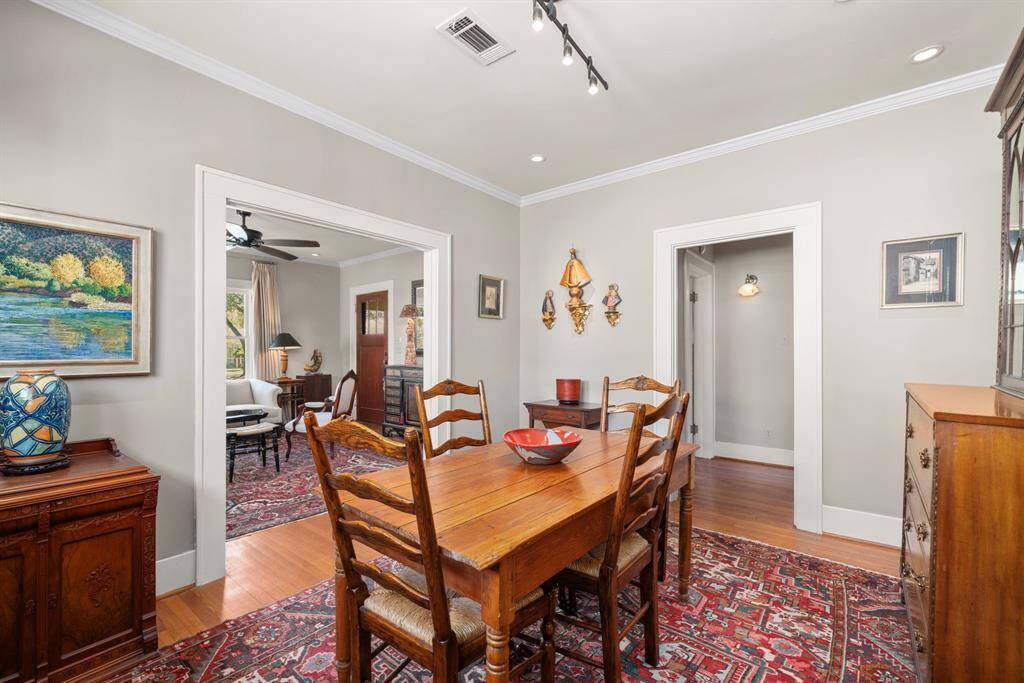The dining area is adjacent to living and kitchen, and offers a continuation of the classic oak hardwood floors.