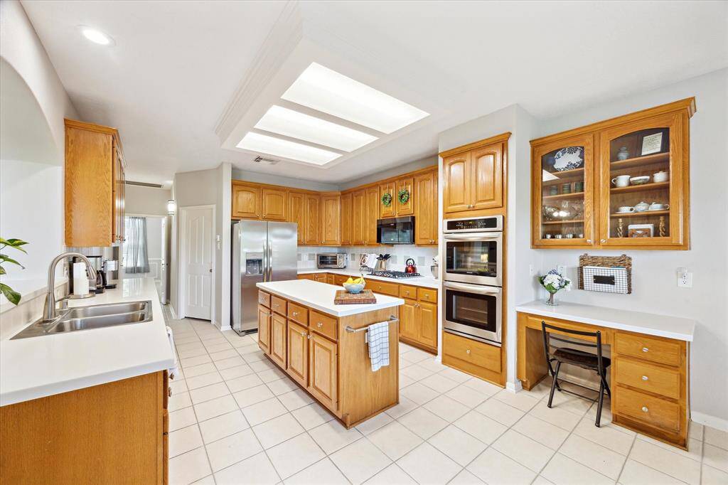 The kitchen really is as big as it looks. Double ovens, gas cooktop, a workspace and walk-in pantry.