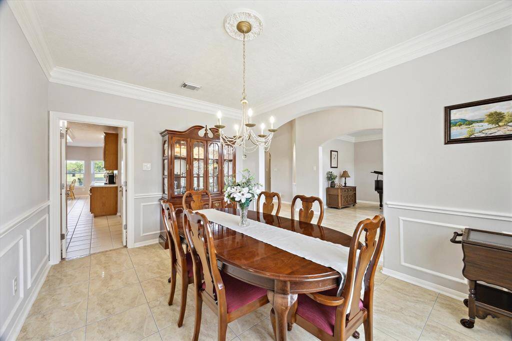 The formal dining room has access to the kitchen. Across the entryway is the formal living room. Add some doors and make it an office.
